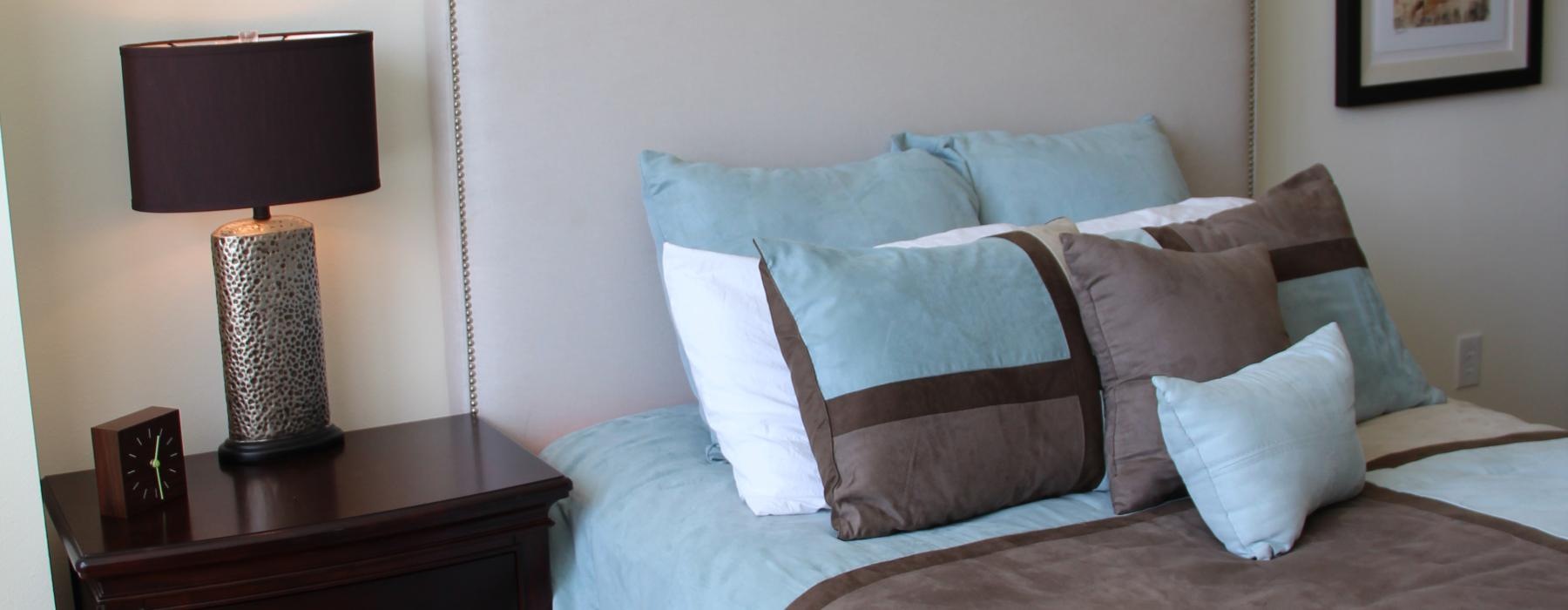 a bed with a lamp on the side