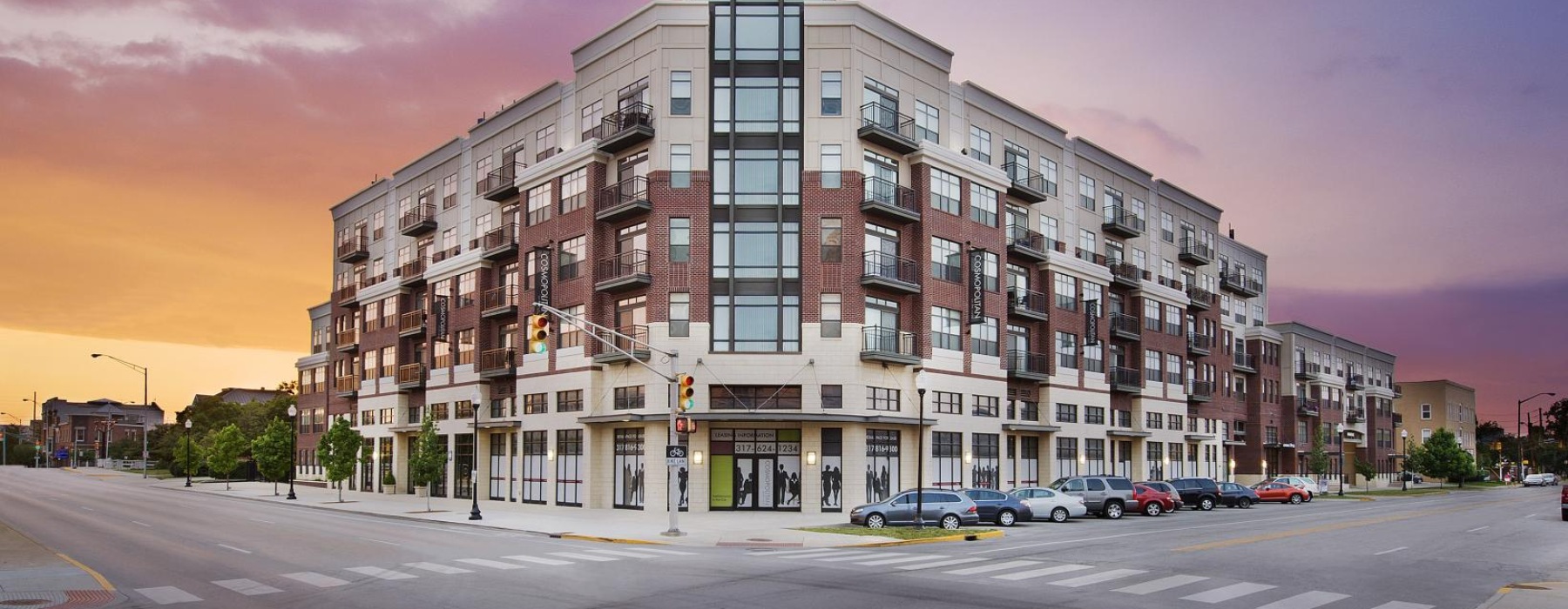 a large building with many windows and a sunset