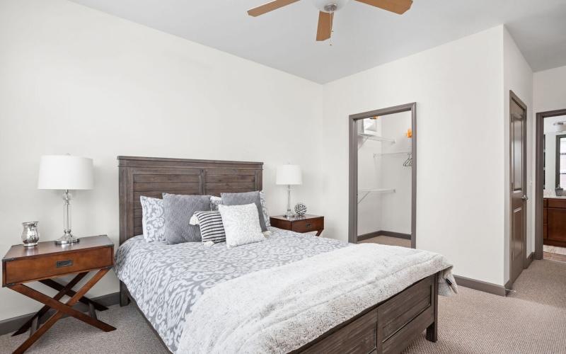 a bedroom with a bed and a fan