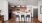 a kitchen with a white table and chairs